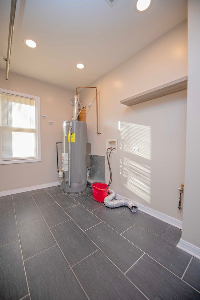 utility room featuring water heater