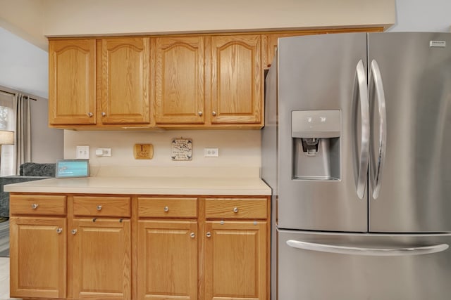 kitchen featuring stainless steel refrigerator with ice dispenser