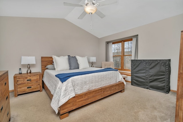 bedroom with ceiling fan, light colored carpet, and vaulted ceiling