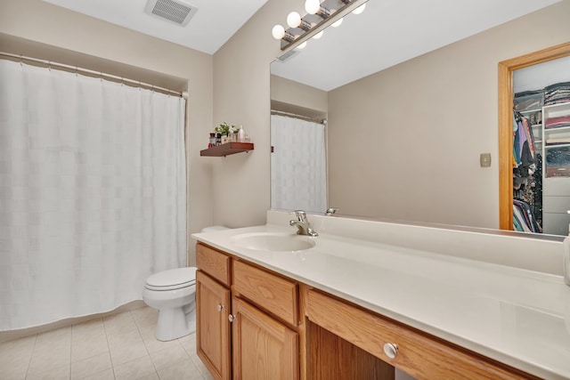 bathroom with tile patterned flooring, vanity, and toilet