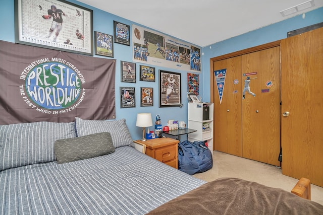 bedroom featuring light carpet and a closet