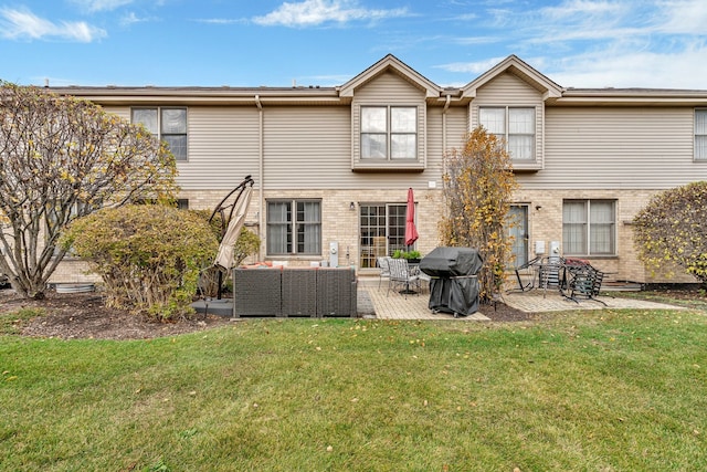 rear view of property with outdoor lounge area, a patio, and a lawn