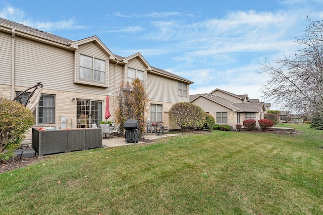 rear view of house featuring outdoor lounge area, a patio area, and a yard