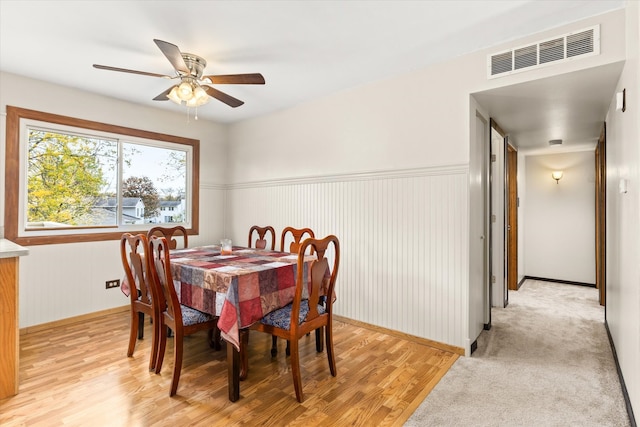 dining room with light hardwood / wood-style flooring and ceiling fan