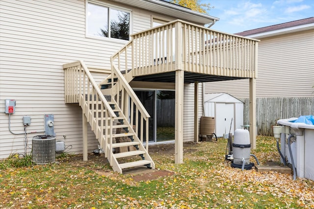 exterior space with cooling unit, a storage unit, and a deck