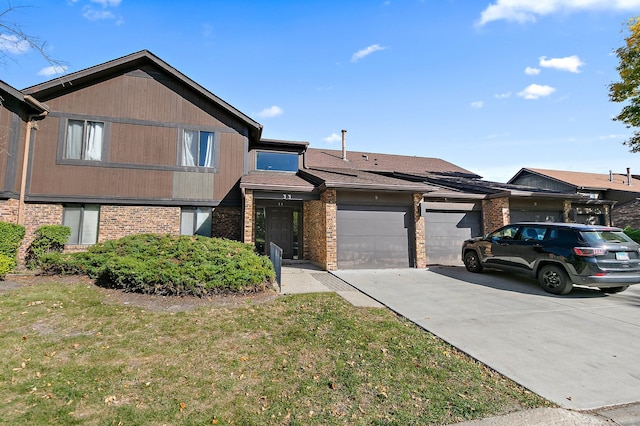 view of front of house with a garage and a front lawn