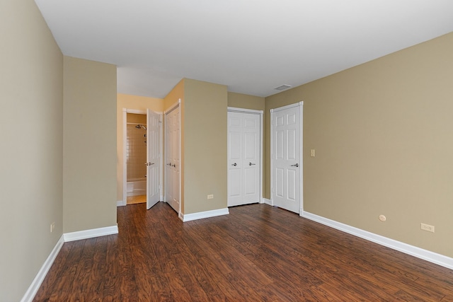 unfurnished bedroom featuring dark wood-type flooring