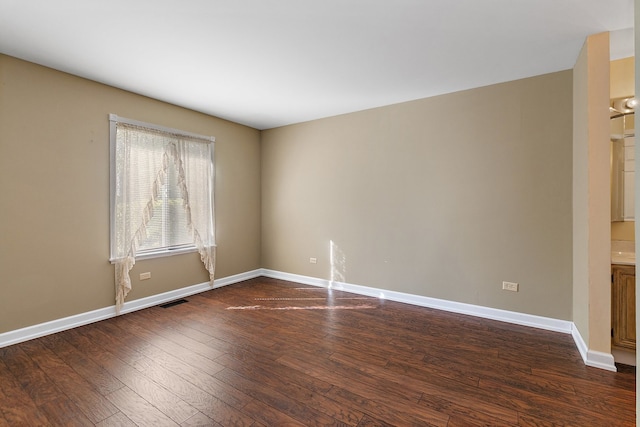 unfurnished room with dark hardwood / wood-style flooring