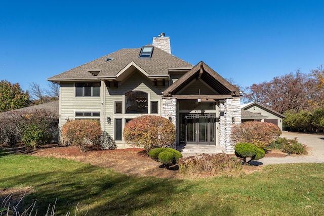 rear view of property with a lawn