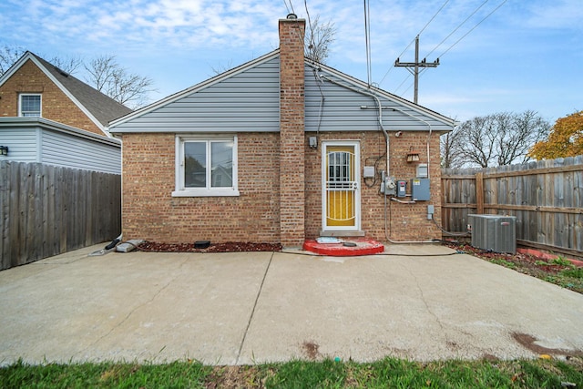 rear view of house featuring a patio and central AC unit