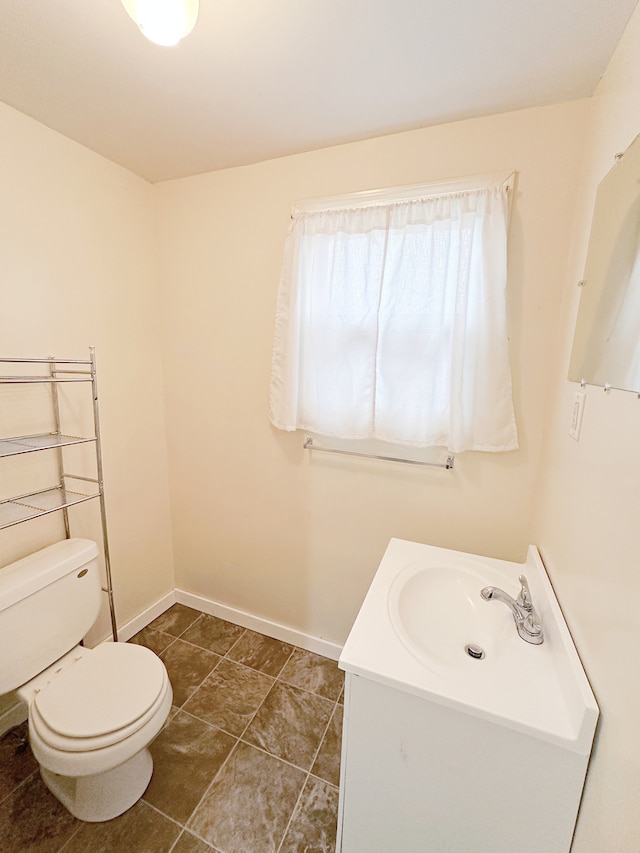 bathroom with tile patterned floors, vanity, and toilet