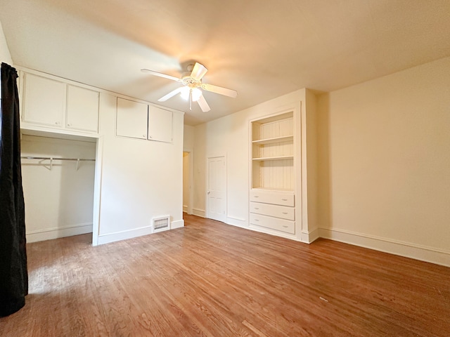 unfurnished bedroom with a closet, hardwood / wood-style flooring, and ceiling fan