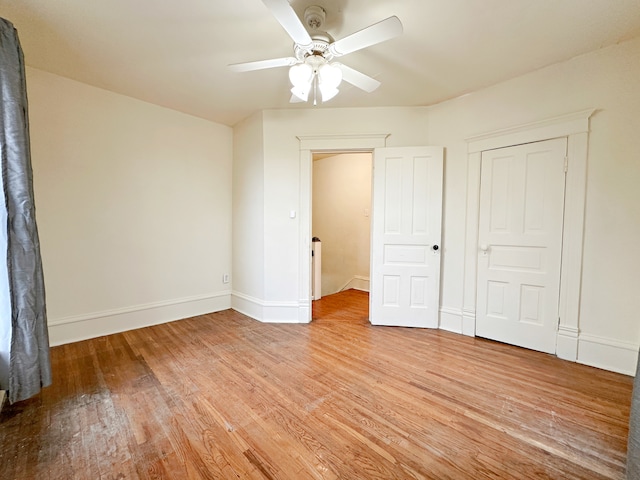 unfurnished bedroom featuring a closet, light hardwood / wood-style floors, and ceiling fan