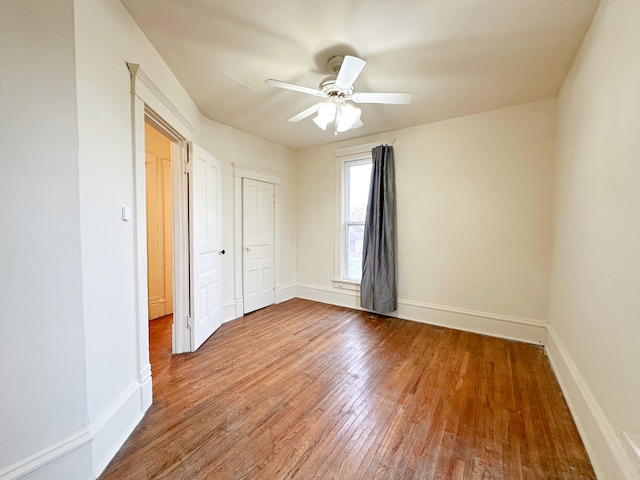 unfurnished bedroom with a closet, ceiling fan, and hardwood / wood-style floors