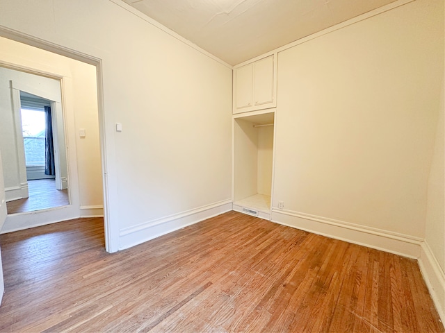 clothes washing area with light hardwood / wood-style floors