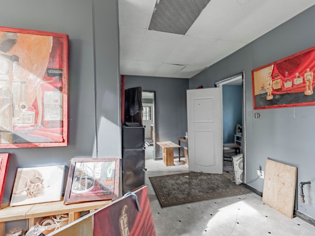 interior space with a paneled ceiling