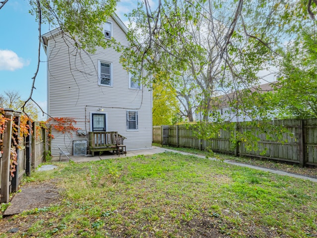 rear view of property with a lawn and a patio area