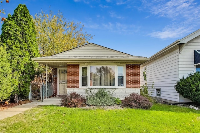 bungalow-style house with a front yard