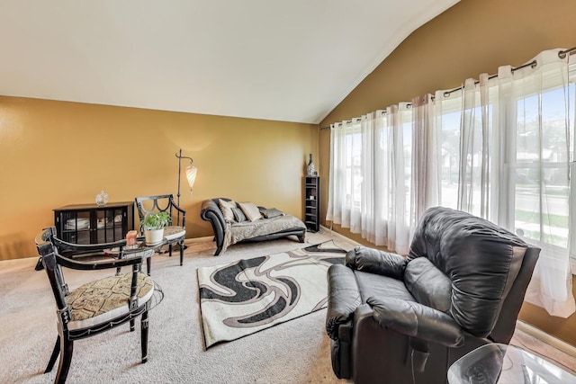 living room featuring lofted ceiling and carpet floors