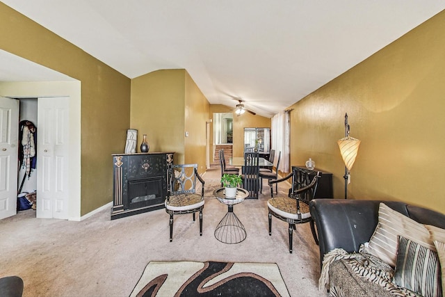 living room with ceiling fan, lofted ceiling, and light colored carpet