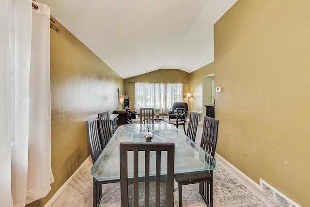 dining room with vaulted ceiling