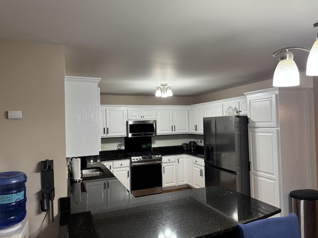 kitchen featuring white cabinetry, kitchen peninsula, and appliances with stainless steel finishes