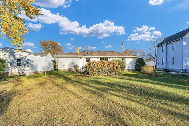 rear view of property with a yard