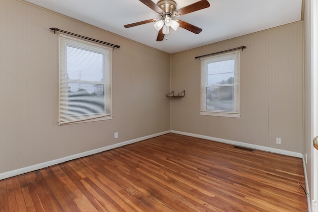 spare room with hardwood / wood-style floors and ceiling fan