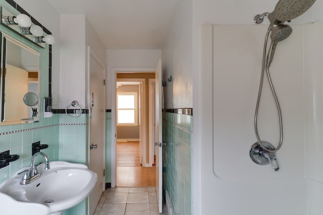 bathroom featuring sink, tile patterned floors, and a shower