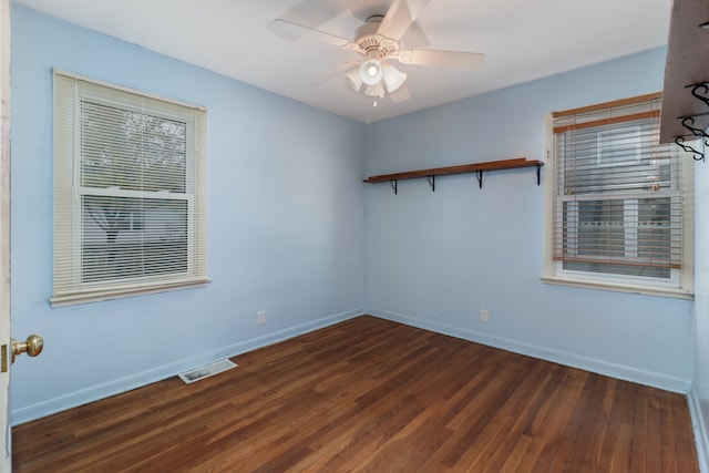 empty room featuring ceiling fan and dark hardwood / wood-style floors