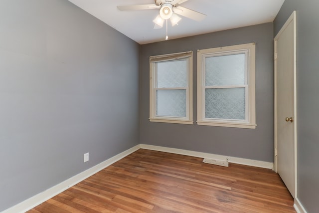 empty room with wood-type flooring and ceiling fan