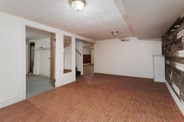 basement featuring a textured ceiling