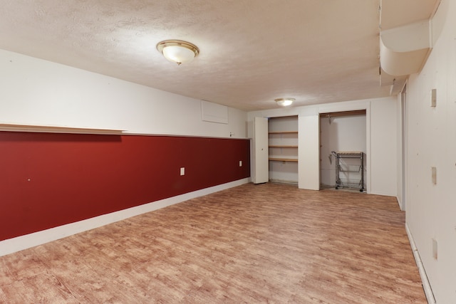 interior space featuring light hardwood / wood-style flooring and a textured ceiling