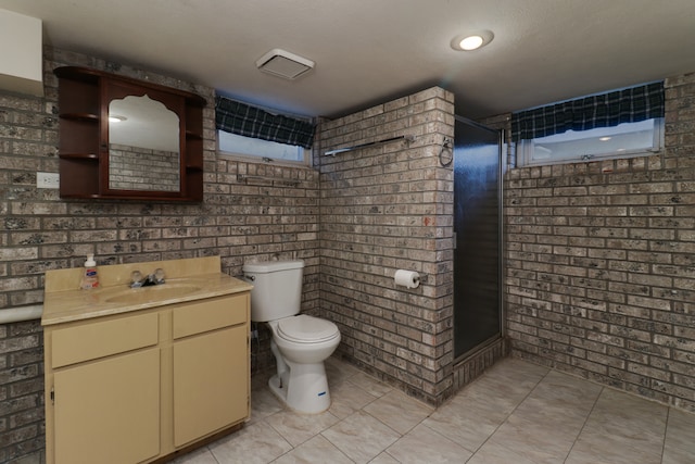 bathroom featuring vanity, tile patterned flooring, toilet, a shower, and brick wall