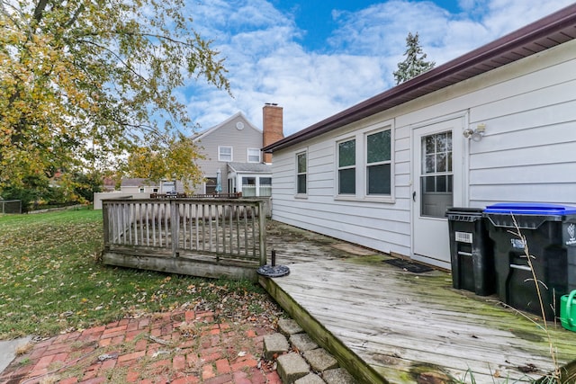 wooden deck featuring a lawn