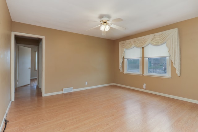 spare room featuring light wood-type flooring and ceiling fan