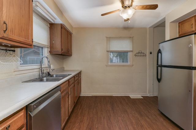 kitchen featuring appliances with stainless steel finishes, sink, ceiling fan, and dark hardwood / wood-style flooring