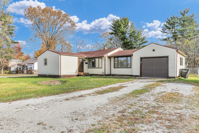 ranch-style home featuring a garage and a front lawn