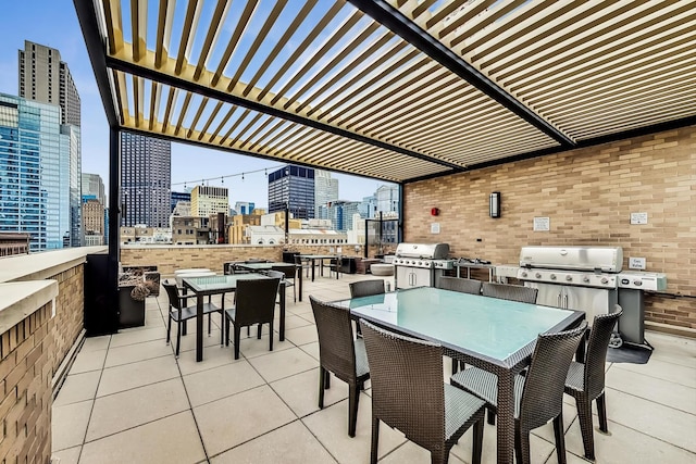 view of patio with outdoor dining area, a city view, area for grilling, and a pergola