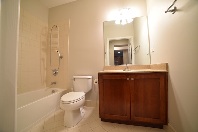 full bathroom featuring toilet, vanity, tiled shower / bath, and tile patterned flooring