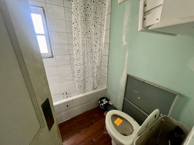 bathroom featuring hardwood / wood-style flooring, toilet, and shower / tub combo