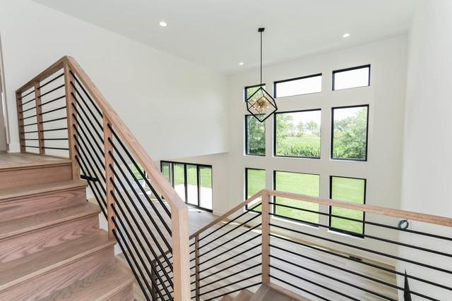 12205 Sinclair Dr, Plainfield, IL 60585 - stairway with recessed lighting, a towering ceiling, wood finished floors, and a chandelier
