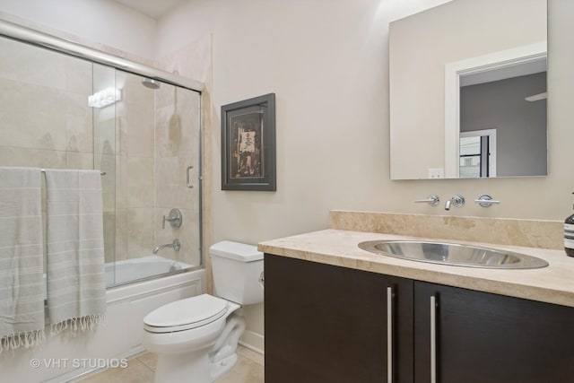 full bathroom with tile patterned flooring, vanity, shower / bath combination with glass door, and toilet