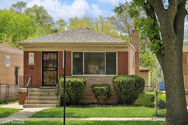 bungalow-style home with a front lawn