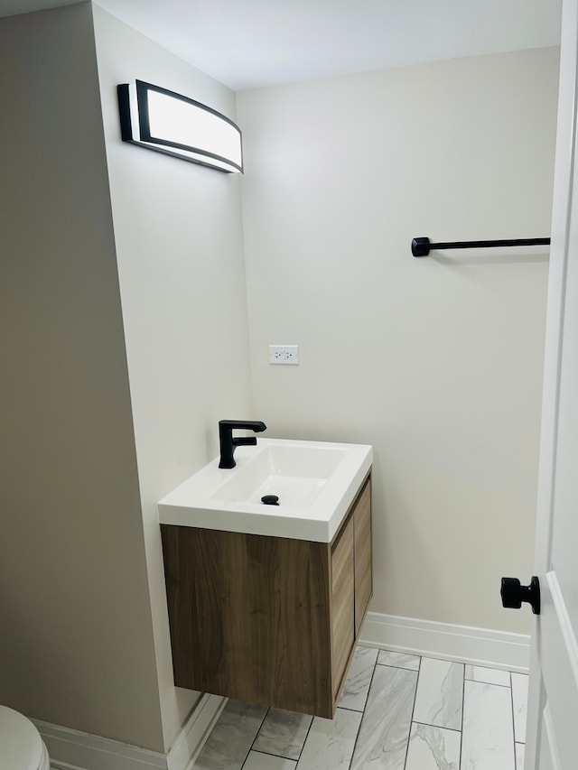 bathroom featuring toilet and vanity