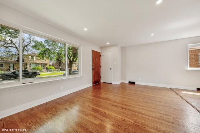 empty room with hardwood / wood-style flooring