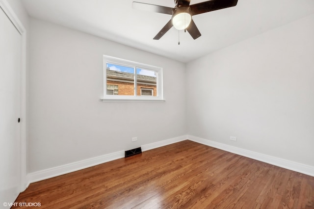 spare room with wood-type flooring and ceiling fan