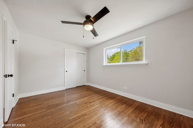 unfurnished bedroom with a closet, wood-type flooring, and ceiling fan