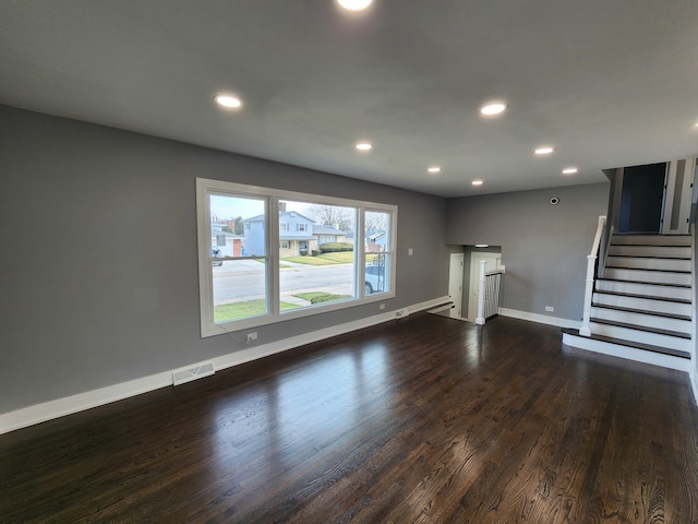 unfurnished living room featuring dark hardwood / wood-style flooring