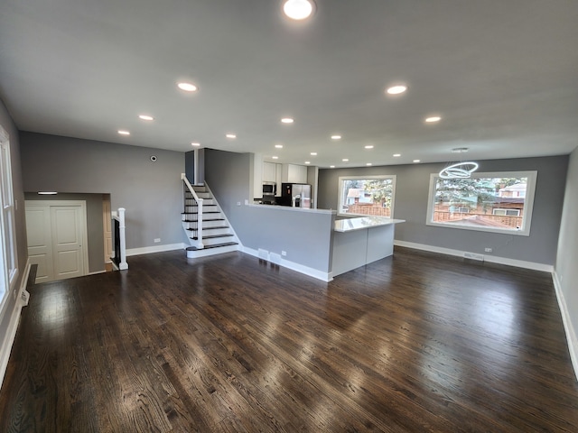 unfurnished living room featuring dark hardwood / wood-style flooring